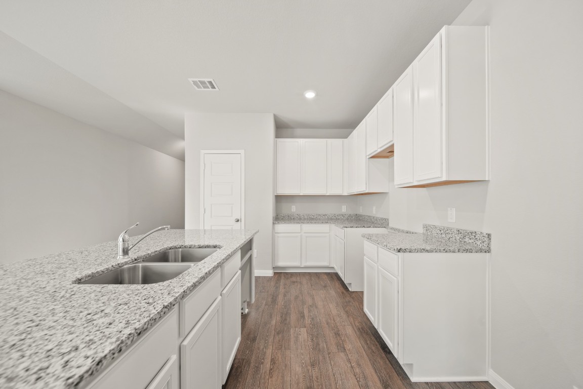 13655 Kit Run Splendora, TX 77372 - Photo 4 of 25 a kitchen with a sink dishwasher a refrigerator and cabinets with wooden floor