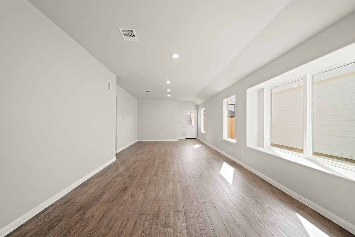 13655 Kit Run Splendora, TX 77372 - Photo 6 of 25 a view of an empty room with wooden floor and a window