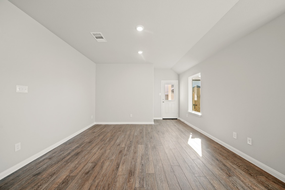 13655 Kit Run Splendora, TX 77372 - Photo 7 of 25 a view of an empty room with wooden floor and a window