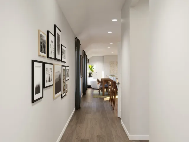 a kitchen with stainless steel appliances kitchen island granite countertop a wooden floor and white cabinets
