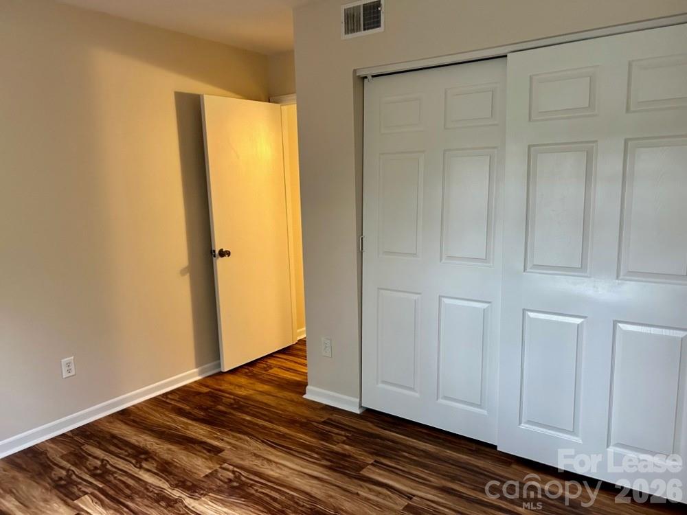 11020 Harrowfield Road Charlotte, NC 28226 - Photo 11 of 14 a view of an empty room with wooden floor