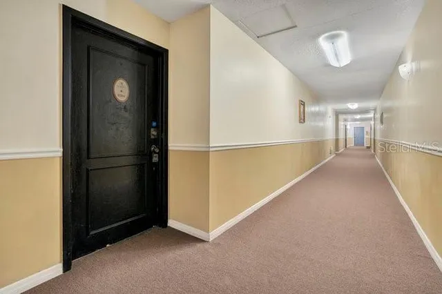a view of an empty room with a ceiling fan