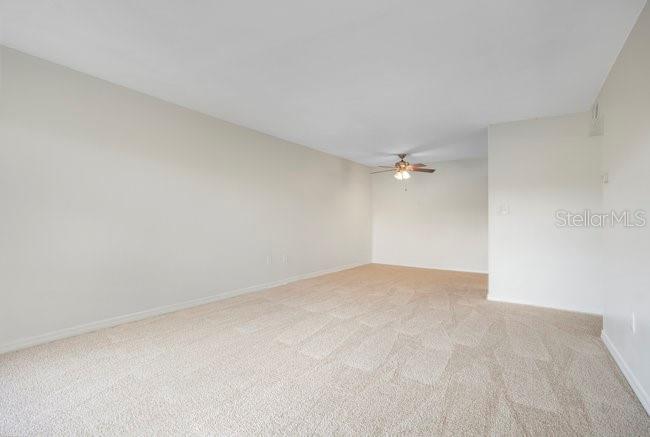 1695 Lee Road, Unit E204 Winter Park, FL 32789 - Photo 3 of 27 a view of an empty room with a ceiling fan