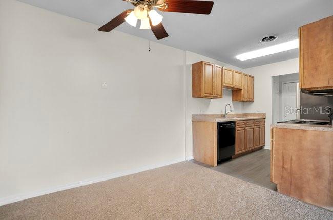 1695 Lee Road, Unit E204 Winter Park, FL 32789 - Photo 8 of 27 a kitchen with stainless steel appliances granite countertop a stove a sink and a microwave
