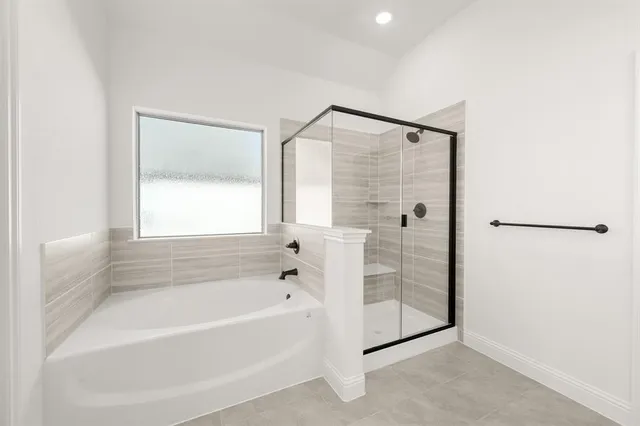 a bathroom with a bathtub and a shower