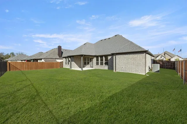 a backyard of a house with table and chairs