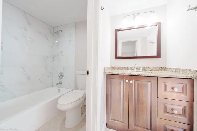 a white bath tub sitting next to a white toilet