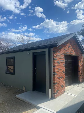 a view of a porch with a floor to ceiling window and a table