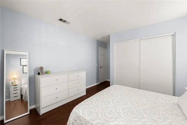 a bedroom with a bed and a dresser