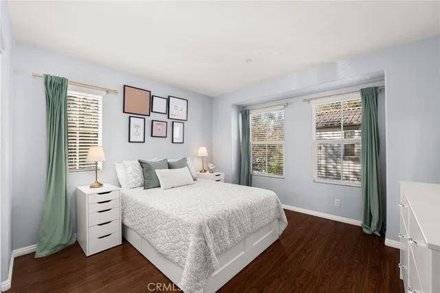 a bedroom with a large bed and a window