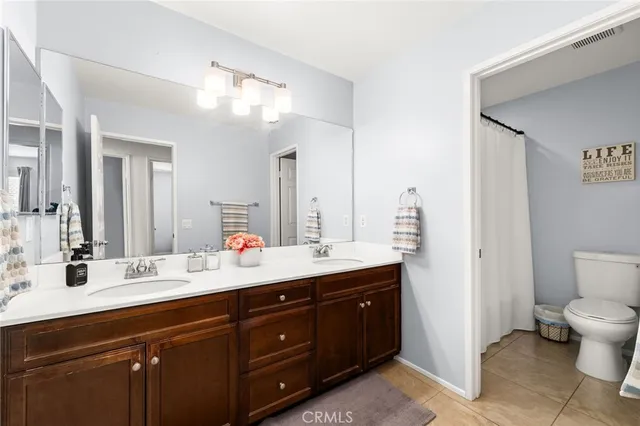 a bathroom with a sink vanity mirror and toilet