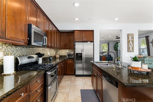 a kitchen with refrigerator and cabinets