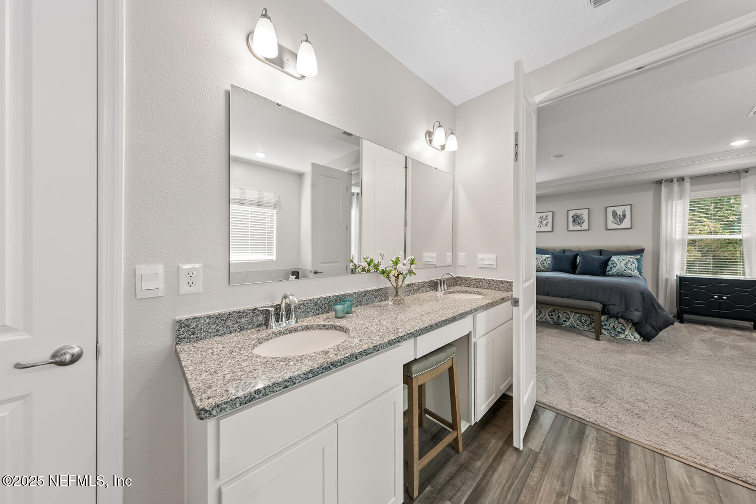 56310 Creekside Way Callahan, FL 32011 - Photo 24 of 47 a spacious bathroom with a granite countertop sink and a mirror