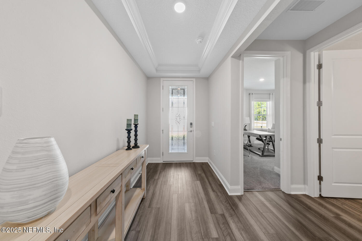 56310 Creekside Way Callahan, FL 32011 - Photo 3 of 47 a view of a hallway with wooden floor and a living room