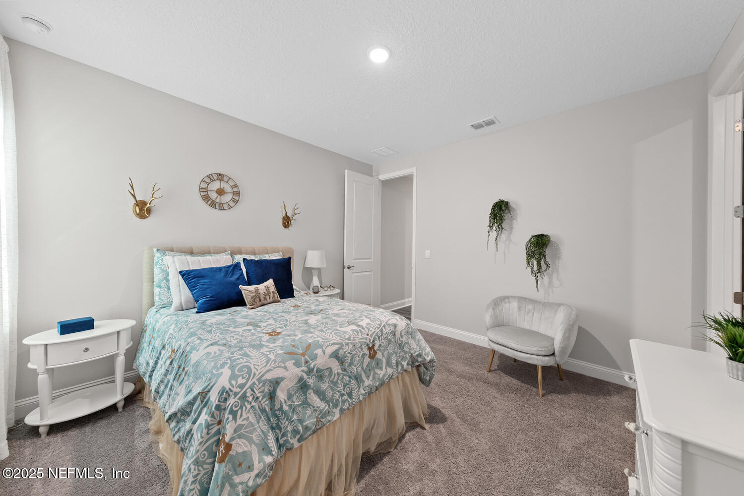 56310 Creekside Way Callahan, FL 32011 - Photo 33 of 47 a bedroom with a bed and a chair