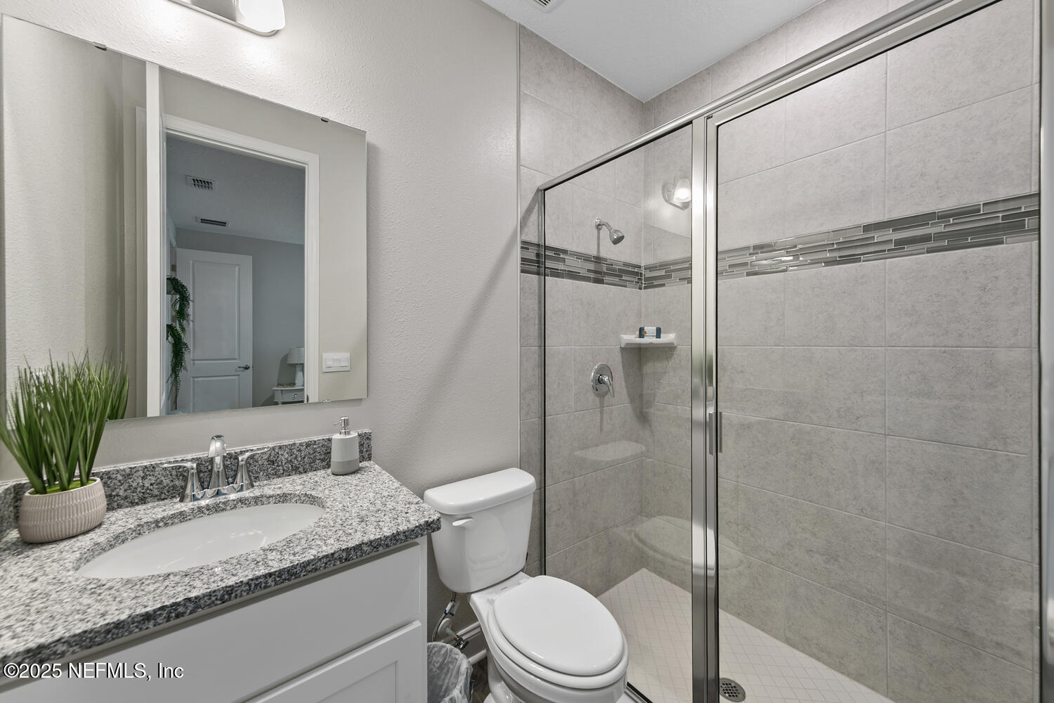 56310 Creekside Way Callahan, FL 32011 - Photo 34 of 47 a bathroom with a granite countertop sink toilet and shower
