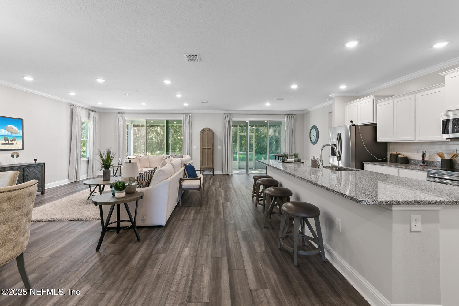 56310 Creekside Way Callahan, FL 32011 - Photo 5 of 47 a living room with stainless steel appliances granite countertop furniture wooden floor and a view of kitchen