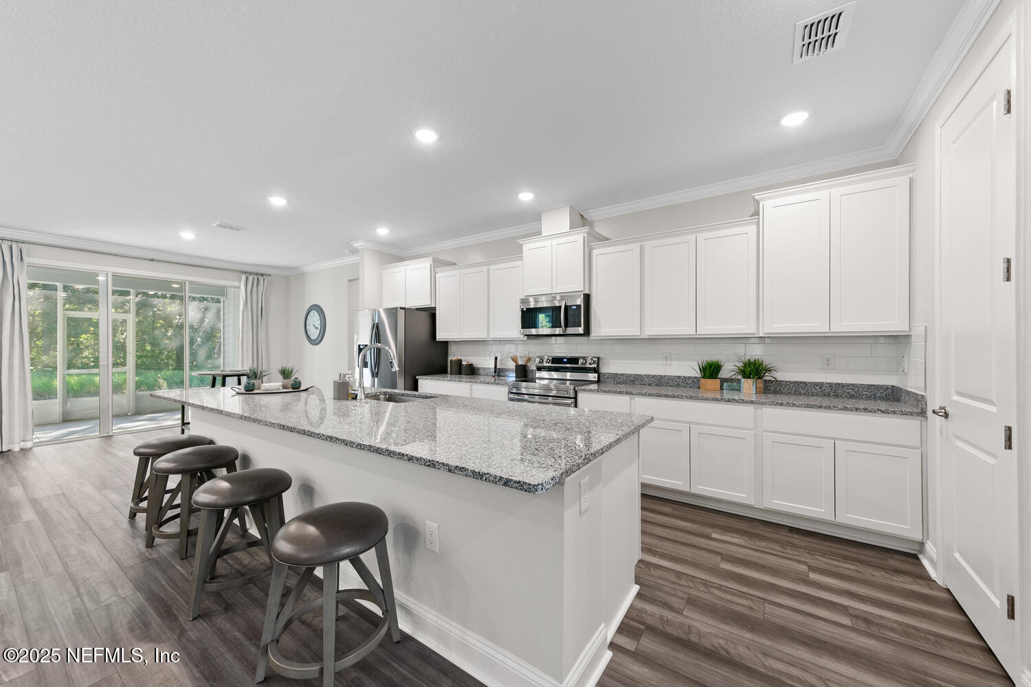 56310 Creekside Way Callahan, FL 32011 - Photo 6 of 47 an open kitchen with granite countertop white cabinets and stainless steel appliances