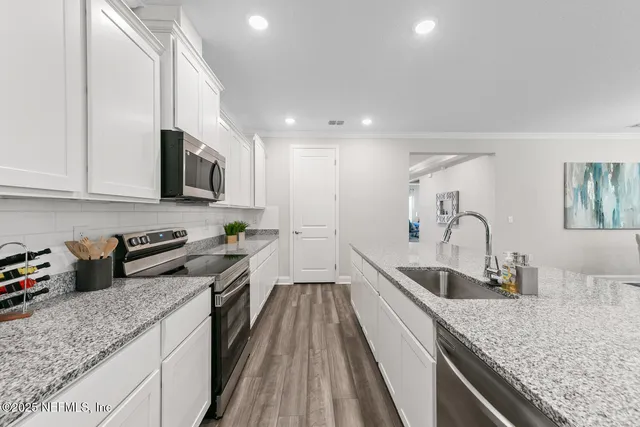 a kitchen with sink stove top oven and microwave