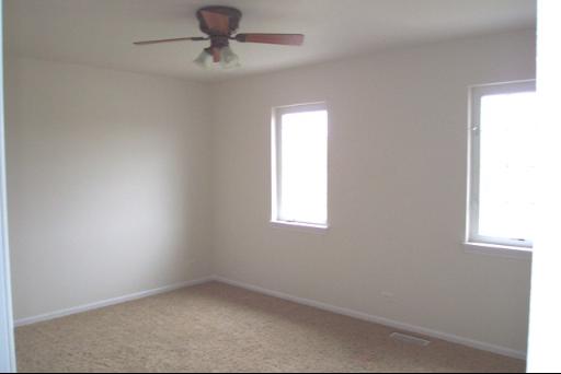 8311 Eagle Ridge Spring Grove, IL 60081 - Photo 15 of 16 an empty room with a window and a ceiling fan