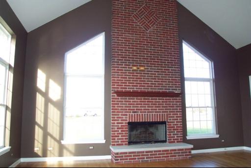 8311 Eagle Ridge Spring Grove, IL 60081 - Photo 6 of 16 a living room with a fireplace and windows