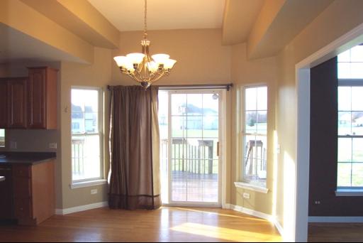 8311 Eagle Ridge Spring Grove, IL 60081 - Photo 9 of 16 a view of a room with a large window and chandelier