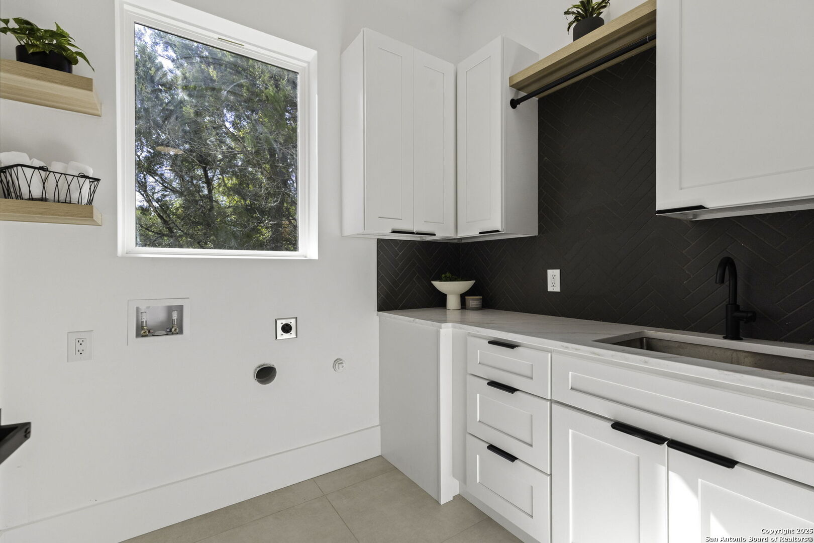 120 River View Boerne, TX 78006 - Photo 22 of 42 a kitchen with white cabinets and window