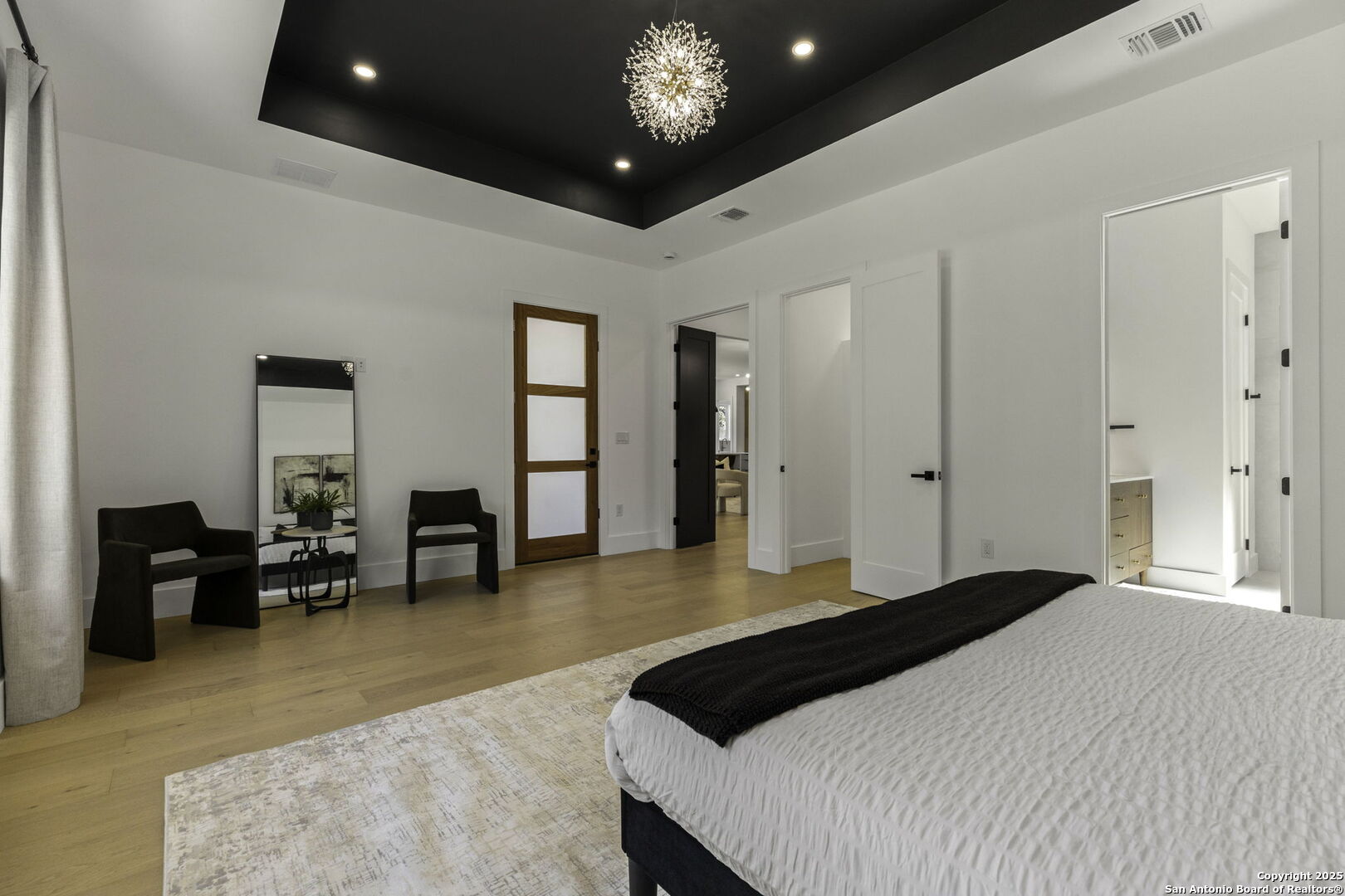 120 River View Boerne, TX 78006 - Photo 26 of 42 a bedroom with a large bed and a chandelier