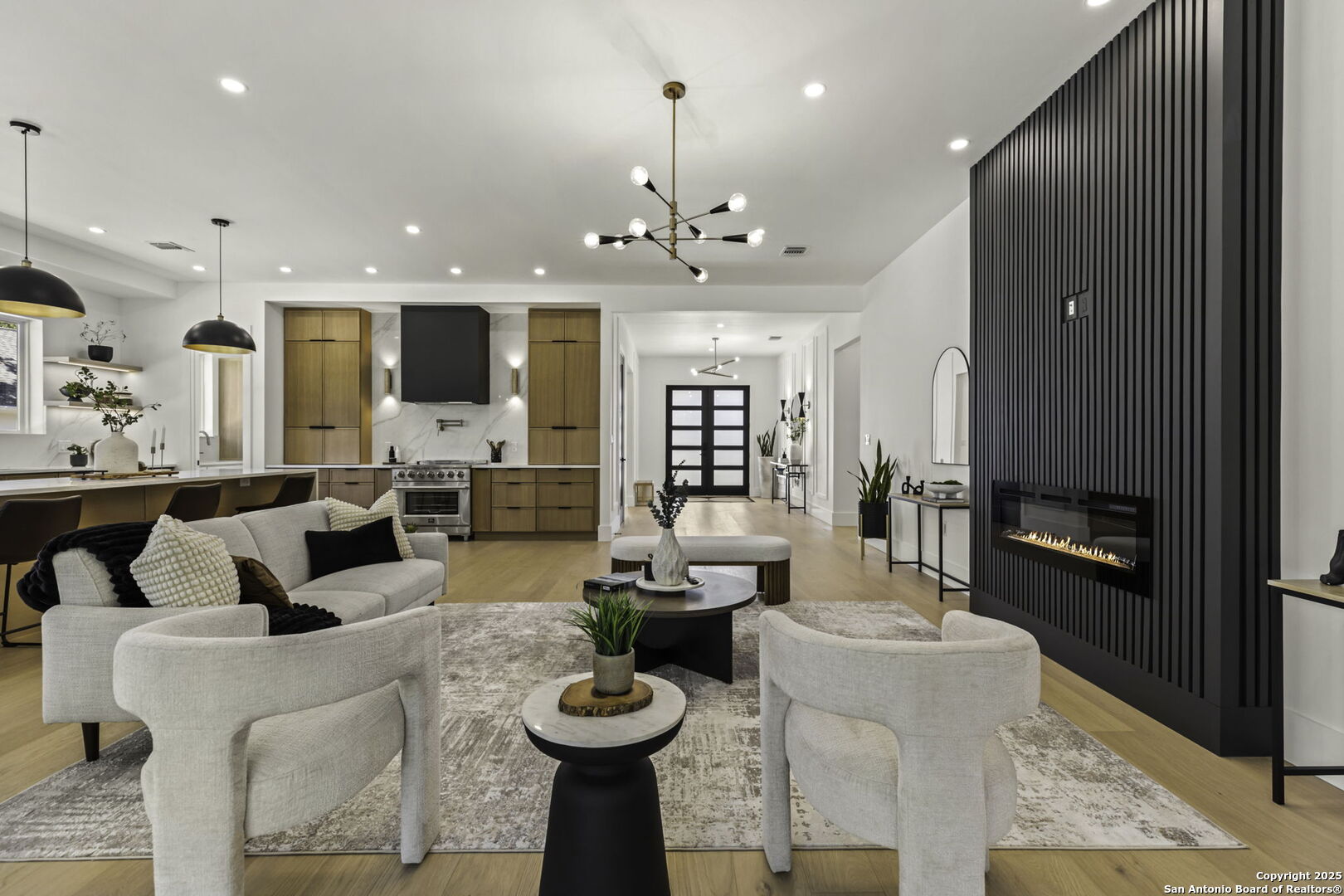 120 River View Boerne, TX 78006 - Photo 10 of 42 a living room with furniture a fireplace and a chandelier
