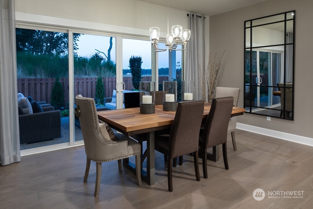 2835 Arrowroot Street Southeast Lacey, WA 98513 - Photo 5 of 19 a view of a dining room with furniture wooden floor and chandelier