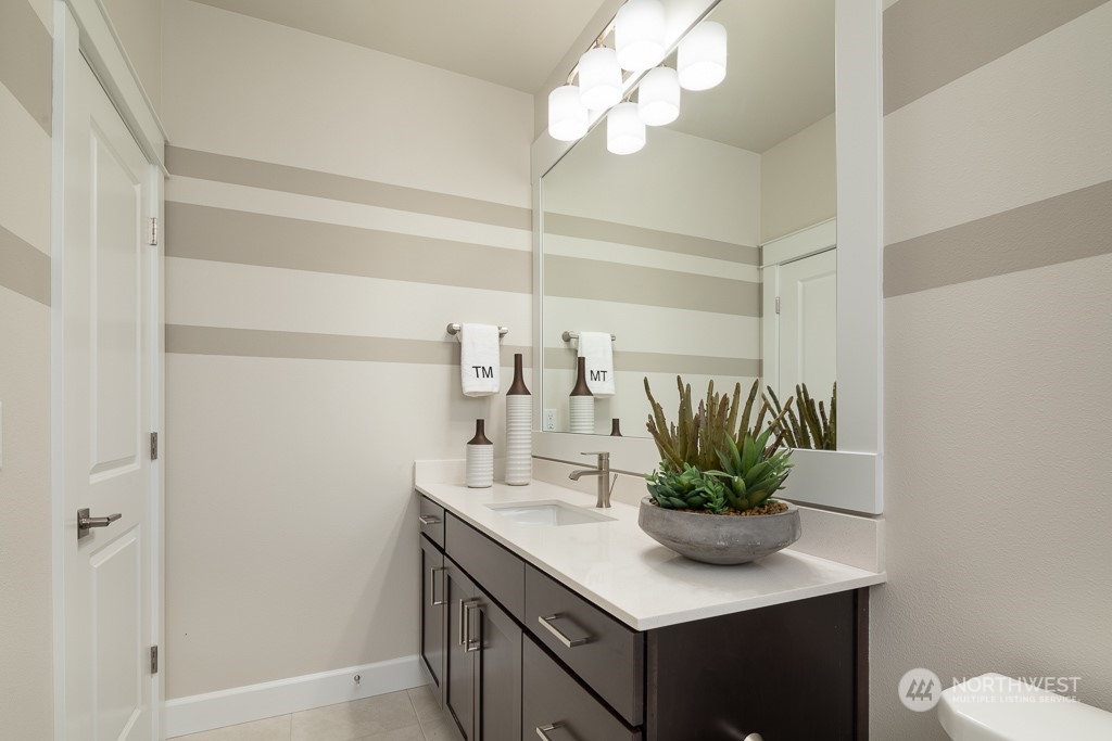 2835 Arrowroot Street Southeast Lacey, WA 98513 - Photo 10 of 19 a bathroom with a sink a mirror and a potted plant