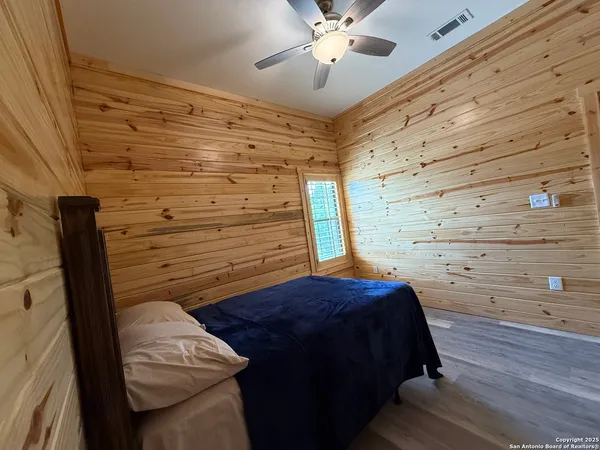 a bedroom with a bed and cabinets