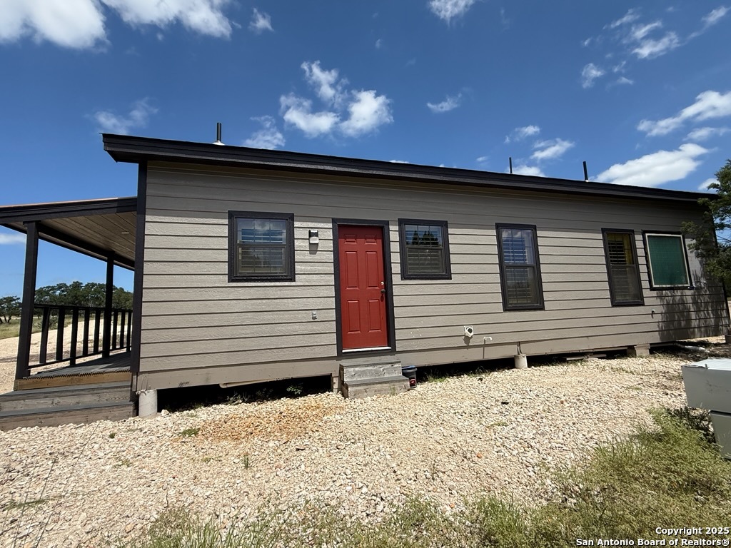 1540 Rough Rider Road Junction, TX 76874 - Photo 25 of 31 a front view of a house with a yard