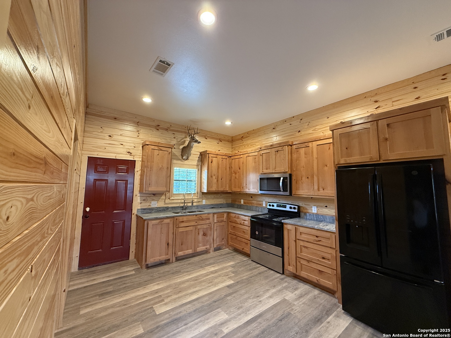 1540 Rough Rider Road Junction, TX 76874 - Photo 3 of 31 a kitchen with granite countertop stainless steel appliances a refrigerator and microwave
