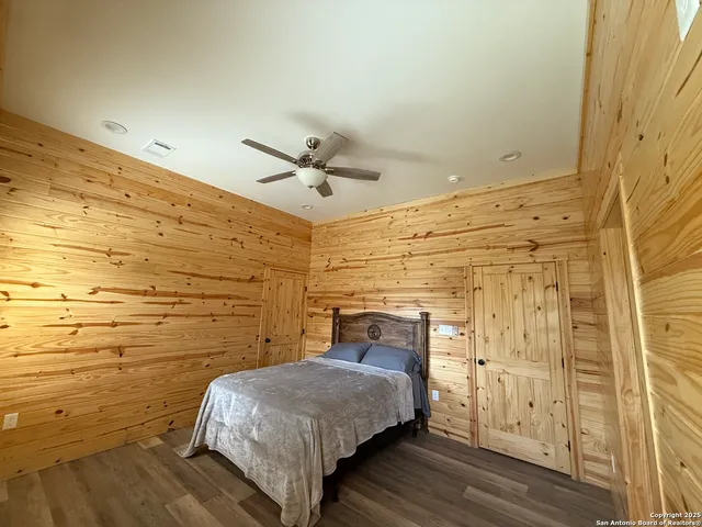 a bedroom with a bed and a ceiling fan