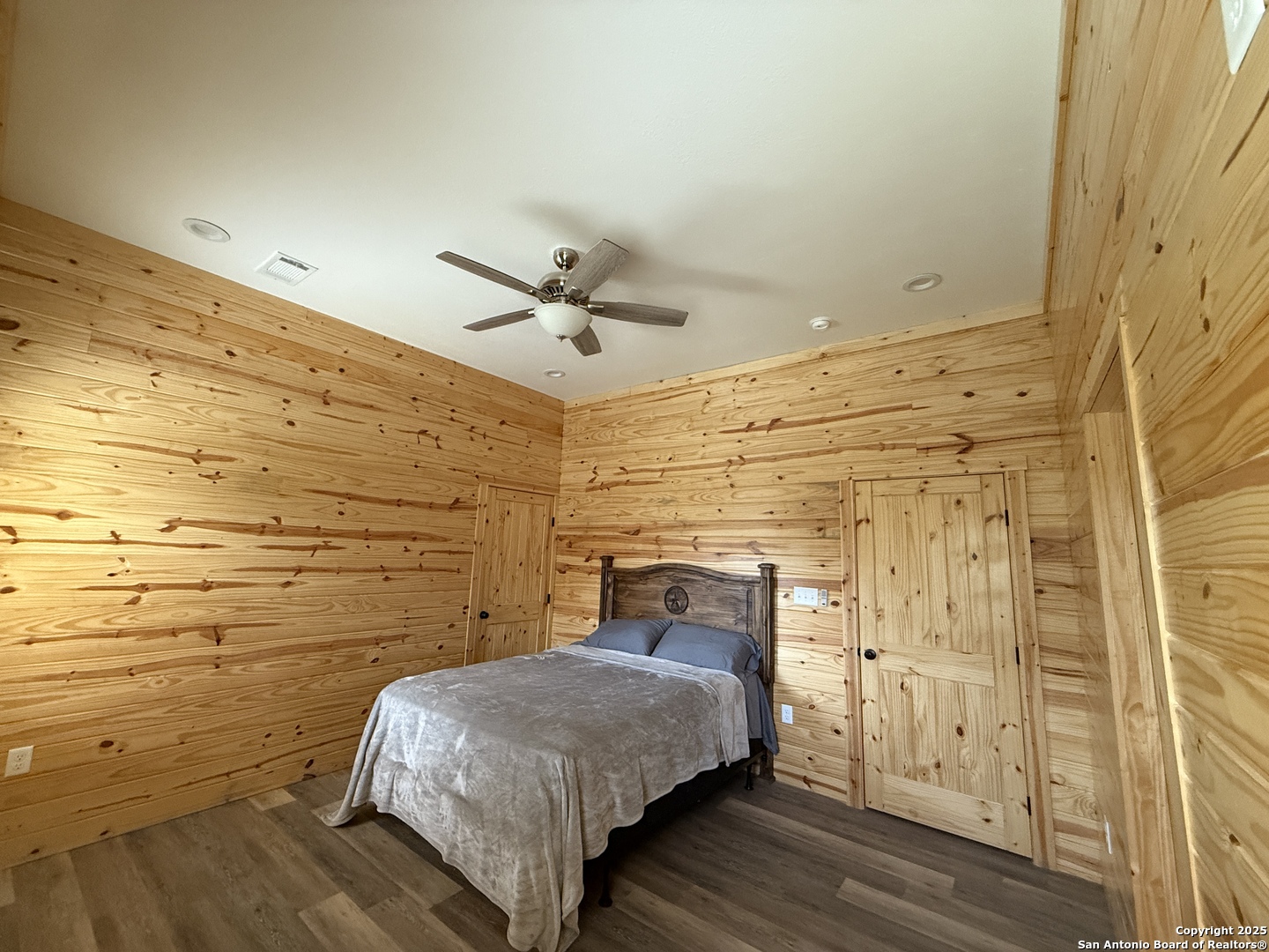 1540 Rough Rider Road Junction, TX 76874 - Photo 5 of 31 a bedroom with a bed and a ceiling fan