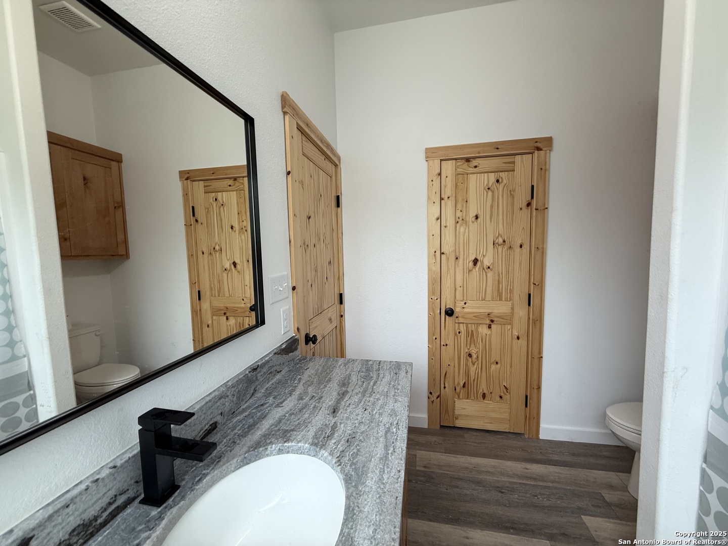 1540 Rough Rider Road Junction, TX 76874 - Photo 7 of 31 a bathroom with a sink and a mirror