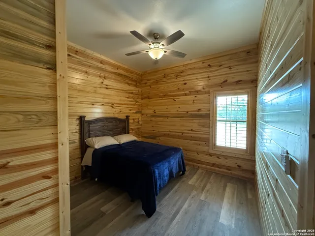 a bedroom with a bed and a ceiling fan