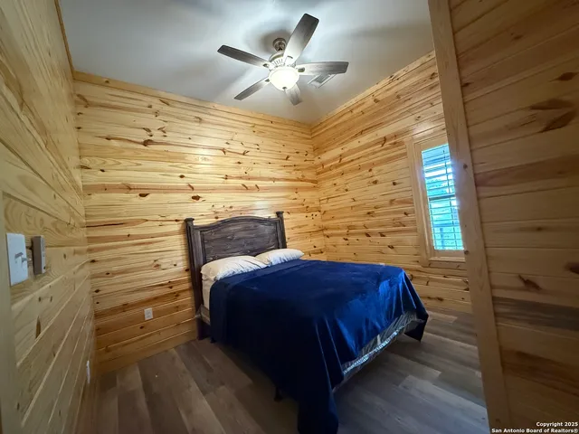 a bedroom with a bed and a ceiling fan