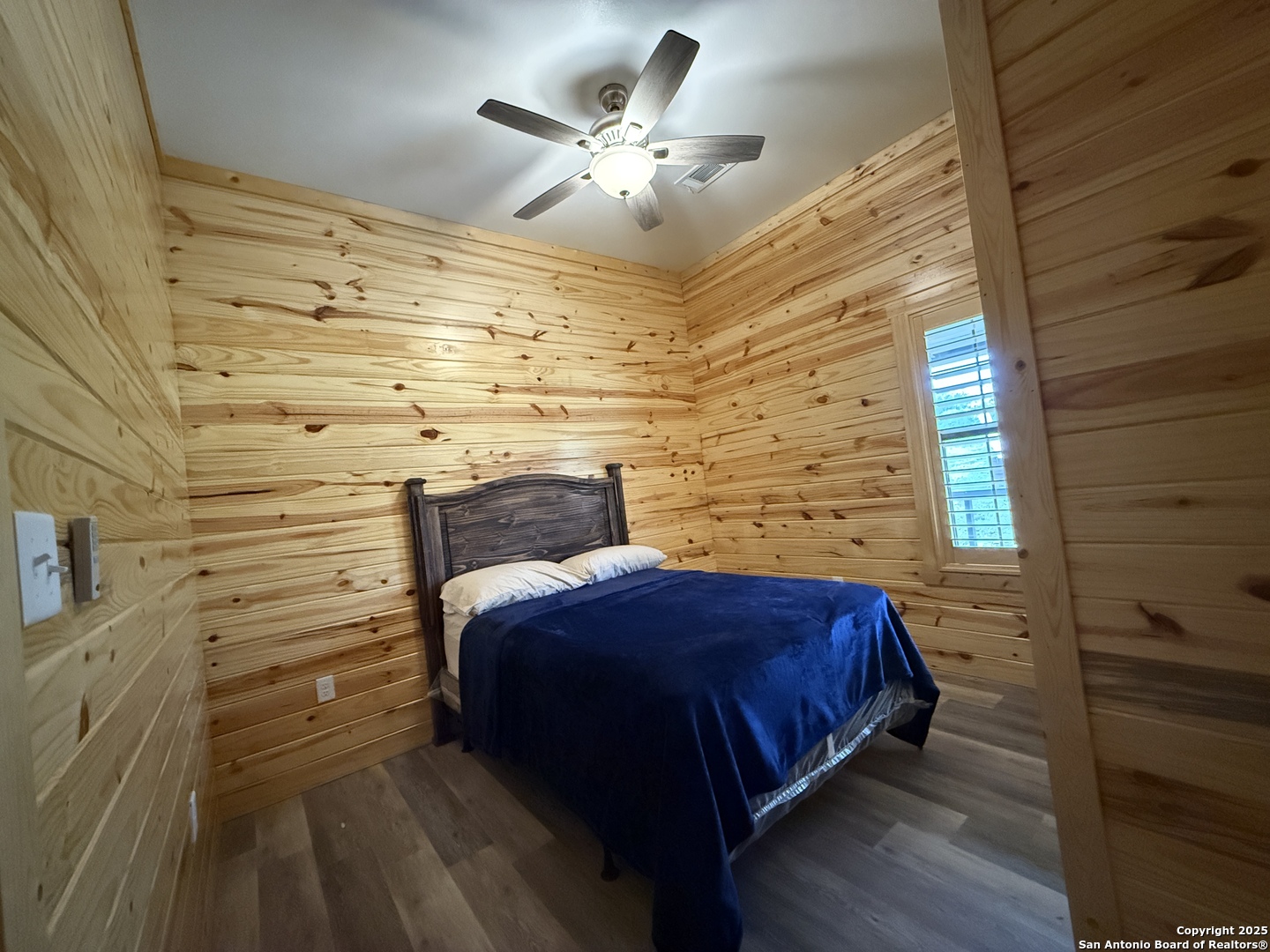 1540 Rough Rider Road Junction, TX 76874 - Photo 9 of 31 a bedroom with a bed and a ceiling fan