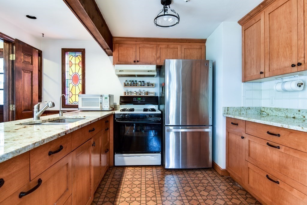 6 Melvin Road Natick, MA 01760 - Photo 12 of 33 a kitchen with stainless steel appliances granite countertop a refrigerator and a sink