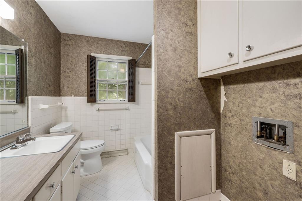 1911 Alderbrook Road Northeast Atlanta, GA 30345 - Photo 22 of 33 a bathroom with a toilet a sink and mirror