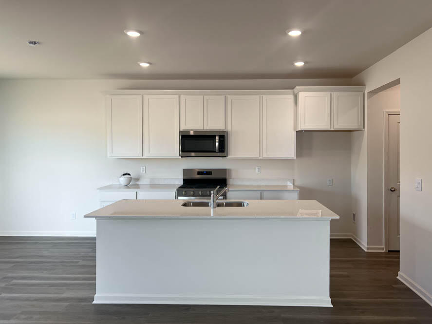 7123 Oakmont Road Mount Pleasant, WI 53403 - Photo 2 of 40 Kitchen with white 42 inch cabinets and white quartz countertops