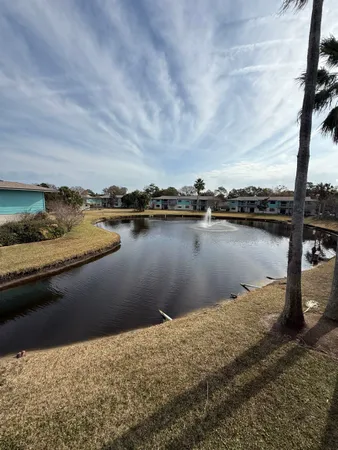 a view of a lake with houses in the back