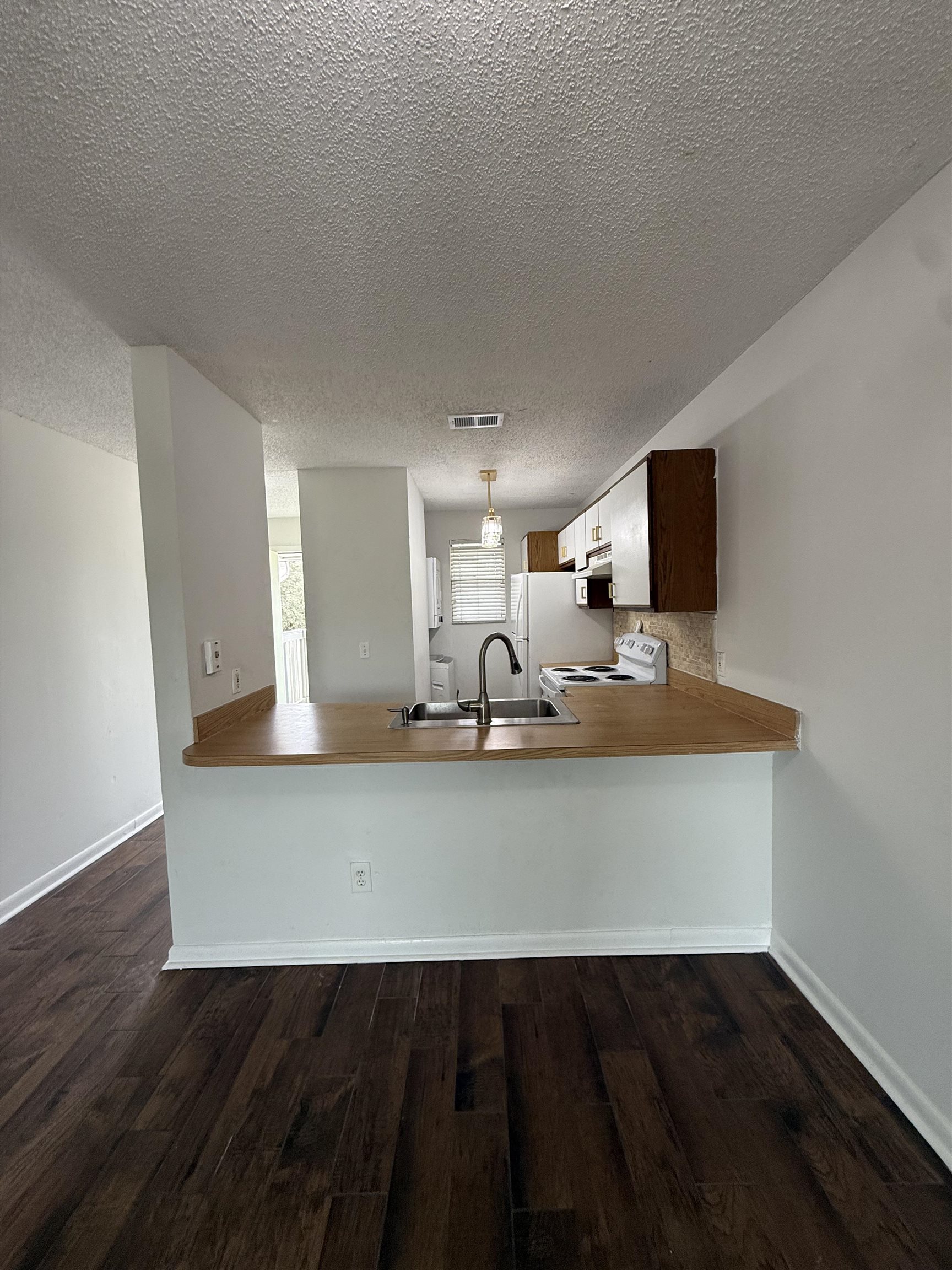 650 West Pope Road, Unit 206 St. Augustine, FL 32080 - Photo 5 of 10 a view of kitchen island with wooden floor