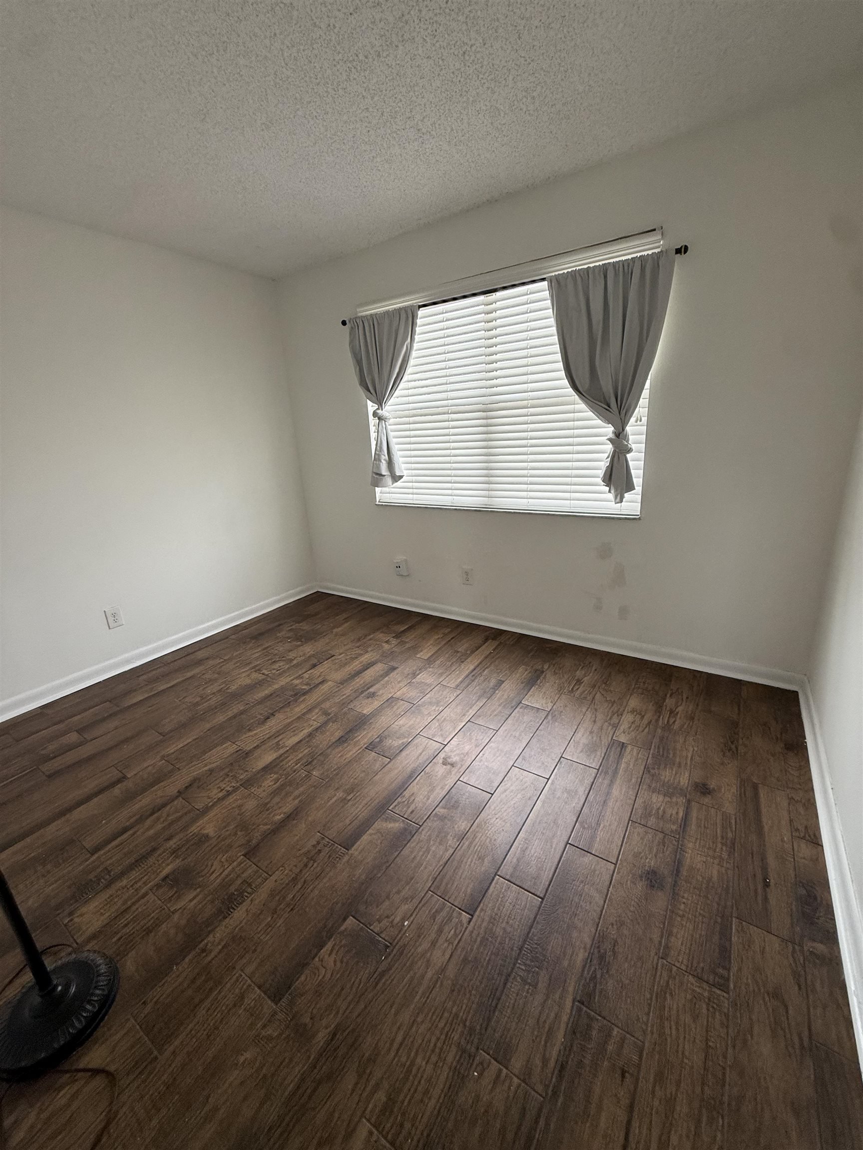 650 West Pope Road, Unit 206 St. Augustine, FL 32080 - Photo 7 of 10 an empty room with wooden floor and windows