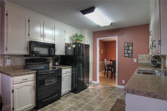 4038 Confederate Road Murfreesboro, TN 37128 - Photo 7 of 16 Plenty of room to cook in this kitchen! Black appliances and tile floors.