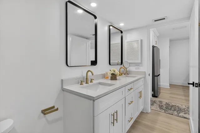 a bathroom with 2 sink and a mirror