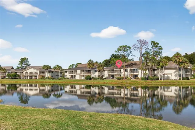 a view of residential houses with outdoor space and lake view