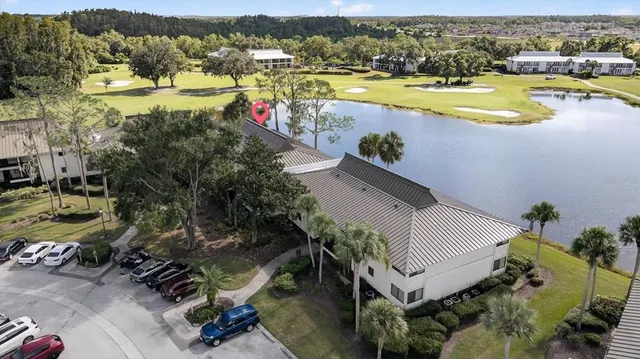 an aerial view of residential houses with outdoor space and trees
